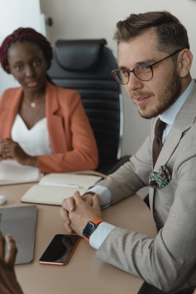Two business professionals engaged in a meeting at the office.